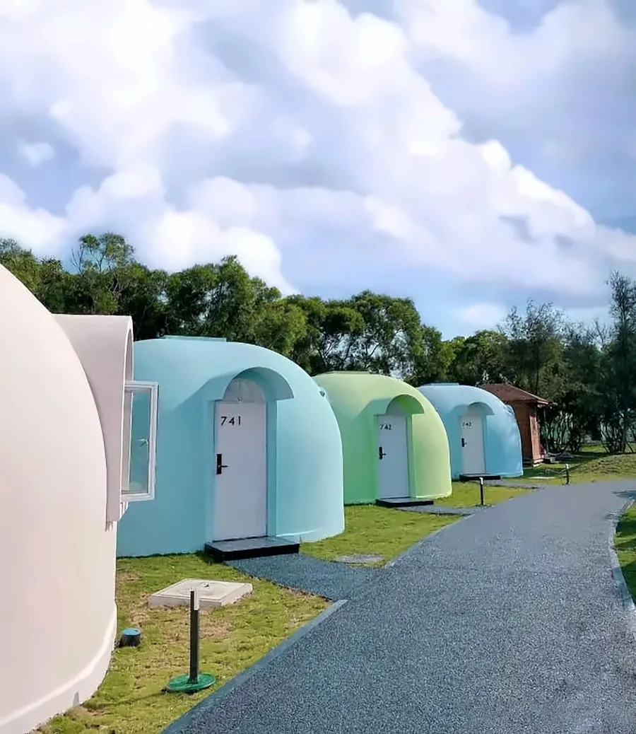 Row of numbered EPS dome guest rooms along a resort path
