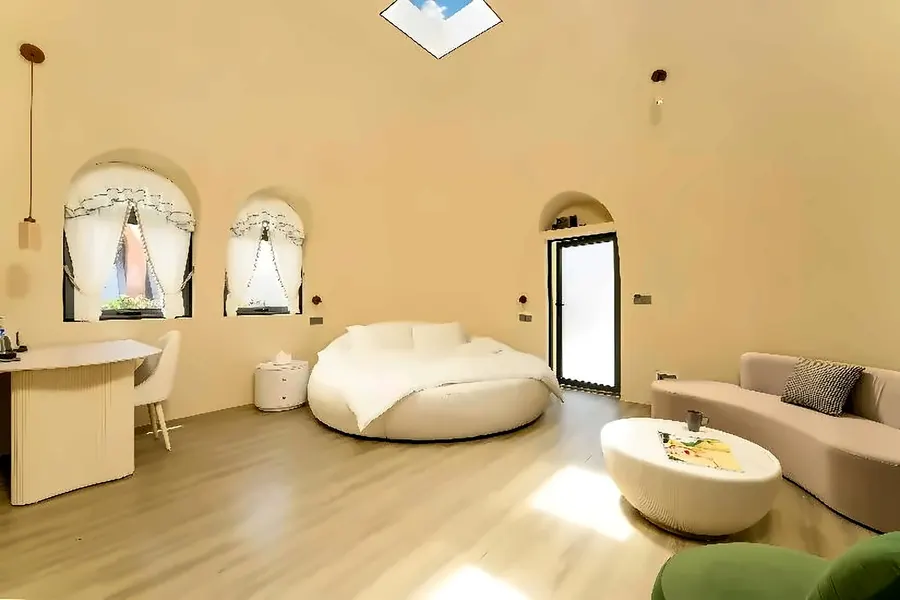 Round-bed dome suite interior with skylight and lounge seating